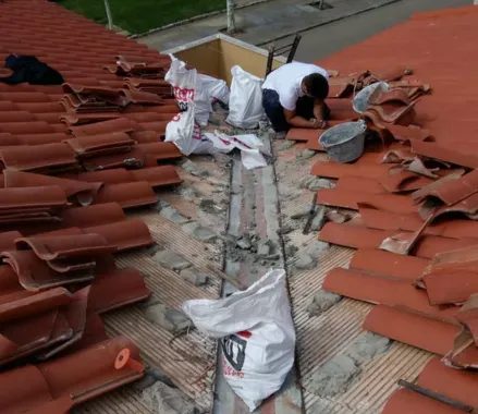 Tejas levantadas para reparar una filtración en la cubierta